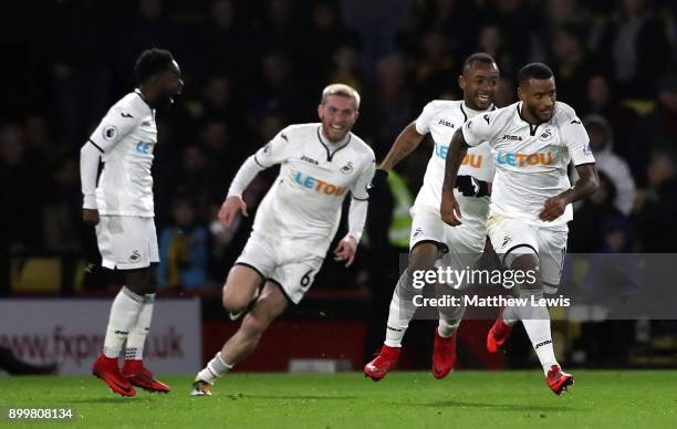 Luciano Narsingh of Swansea City celebrates with teammates after scoring his sides second goal during the Premier League match between Watford and...