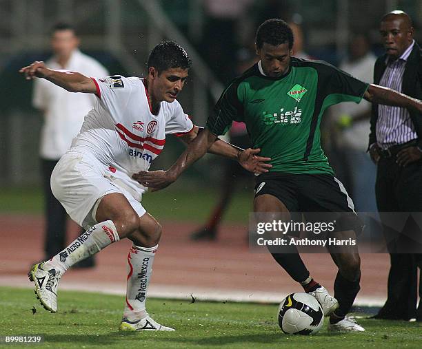 Francisco Gamboa of Mexico's Toluca vies for the ball with Lester Peltier of San Juan Jabloteh during their match for Concacaf Champions League at...