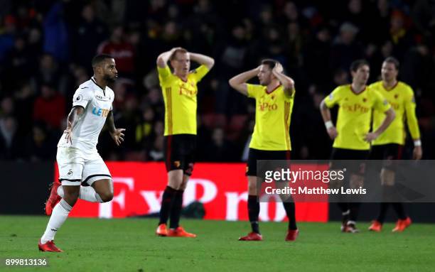 Tom Cleverley of Watford and teammate Ben Watson look dejected as Luciano Narsingh of Swansea City celebrates after scoring his sides second goal...