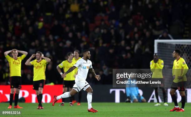 Watford players look dejected as Luciano Narsingh of Swansea City celebrates after scoring his sides second goal during the Premier League match...