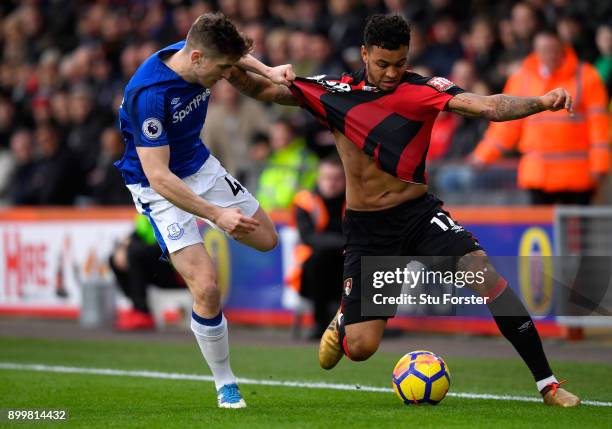 Joshua King of AFC Bournemouth and Jonjoe Kenny of Everton battle for the ball during the Premier League match between AFC Bournemouth and Everton at...