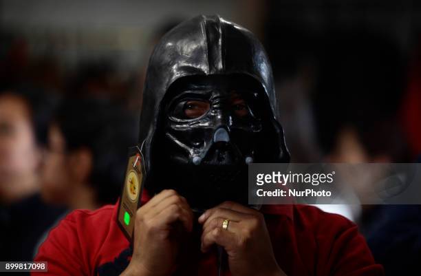 Person tries on the mask of Darth Vader, characters that the Ecuadorians will 'burn' to celebrate the end of the year on December 31 in Quito,...