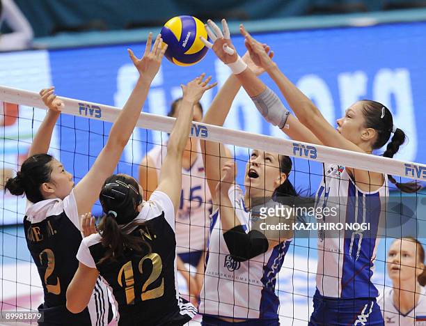 Russian players Ekaterina Gamova and Maria Borodakova vie for the ball with Chinese players Xue Ming and Yin Na during their match of the World Grand...