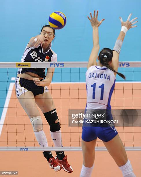 China's Chu Jinling spikes the ball past Russia's Ekaterina Gamova during a match of the World Grand Prix women's volleyball tournament final round...