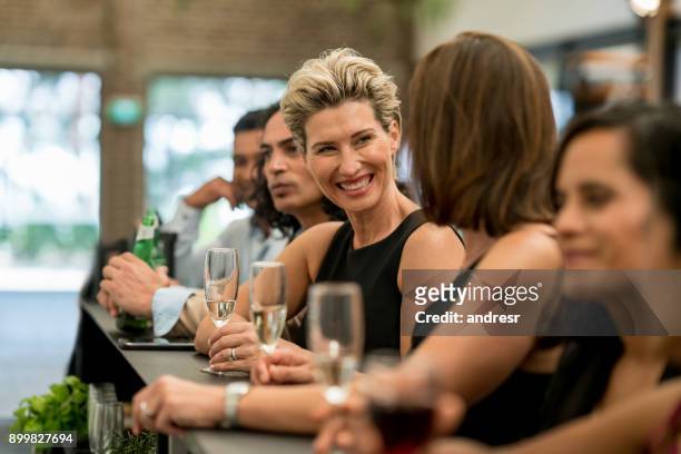 group of business people having drinks at a bar - evento stock pictures, royalty-free photos & images