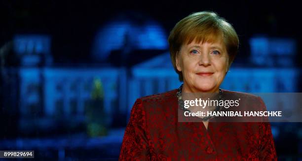 German Chancellor Angela Merkel poses for a photograph after the recording of her annual New Year's speech at the Chancellery in Berlin on December...