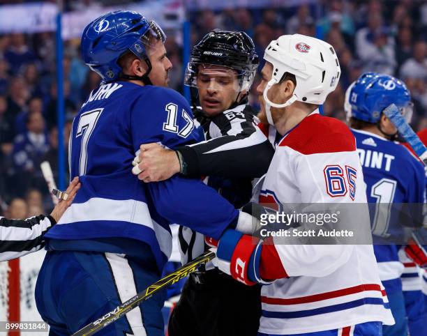 Alex Killorn of the Tampa Bay Lightning skates against Andrew Shaw of the Montreal Canadiens during the first period at Amalie Arena on December 28,...