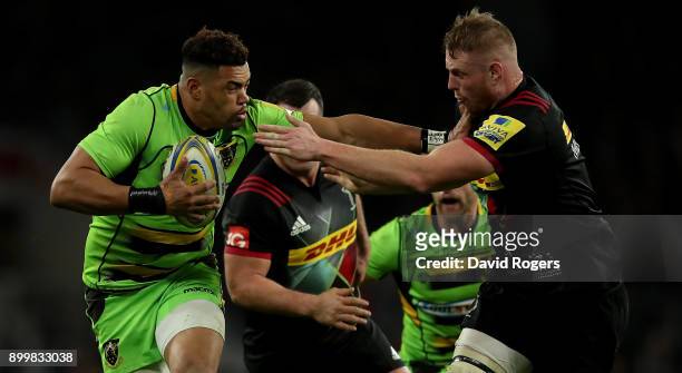 Luther Burrell of Northampton Saints hands off George Merrick of Harlequins during the Aviva Premiership Big Game 10 match between Harlequins and...