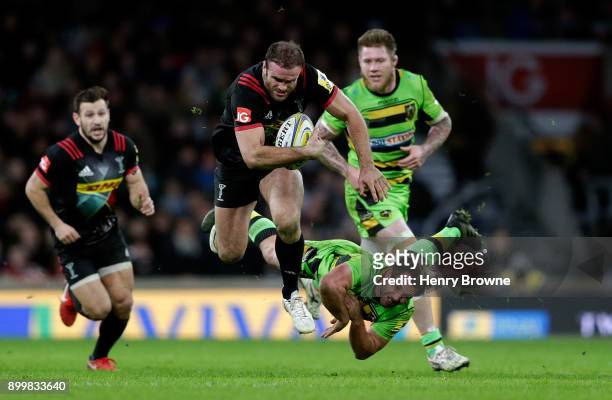 Jamie Roberts of Harlequins is tackled by Nic Groom of Northampton Saints during the Aviva Premiership Big Game 10 match between Harlequins and...