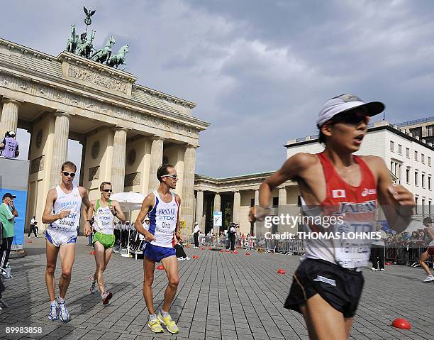 Japan's Yuki Yamazaki and France's Yohan Diniz, Australia's Jared Tallent and Italy's Alex Schwazer walk past landmark Brandenburg Gate during the...