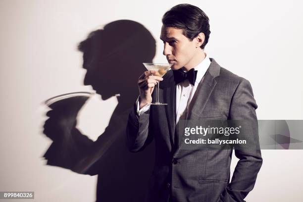 man with a bowtie in a nightclub - dinner jacket stock pictures, royalty-free photos & images