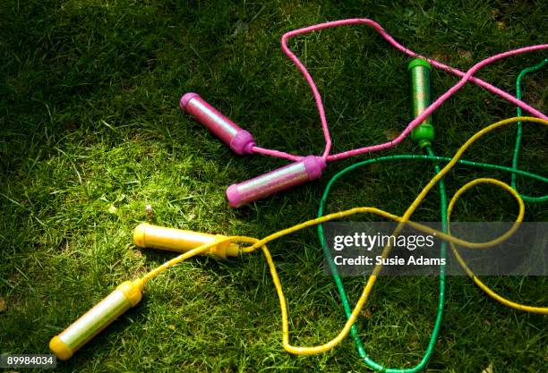 three skipping ropes on grass - skipping rope stock pictures, royalty-free photos & images