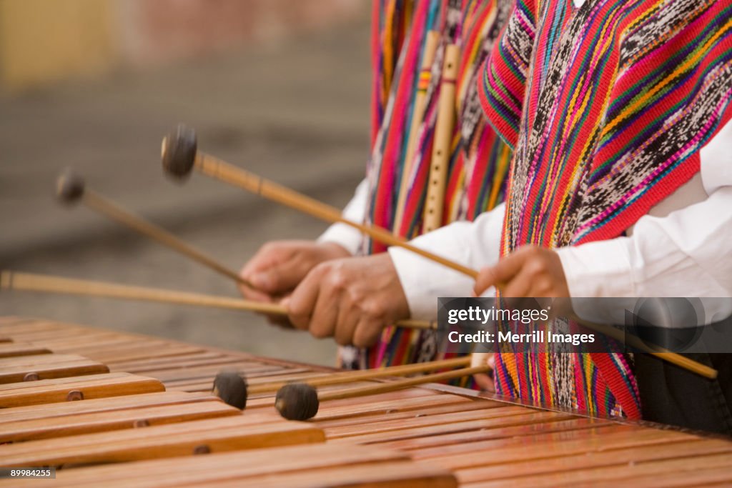 Hands of musicians playing marimba.
