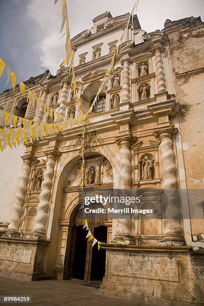 cathedral entrance, adorned with flags - antigua guatemala stock pictures, royalty-free photos & images