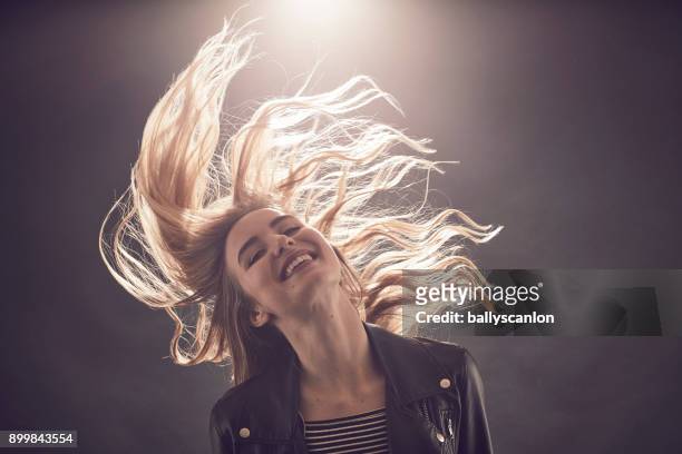 woman dancing in a nightclub - blonde hair black background stock pictures, royalty-free photos & images