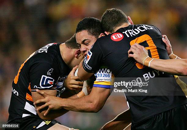 Jarryd Hayne of the Eels is tackled during the round 24 NRL match between the Wests Tigers and the Parramatta Eels at the Sydney Football Stadium on...