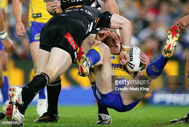 Jeff Robson of the Eels is tackled heavily during the round 24 NRL match between the Wests Tigers and the Parramatta Eels at the Sydney Football...