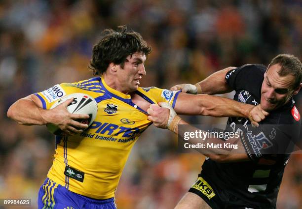 Nathan Hindmarsh of the Eels puts a fend on Gareth Ellis of the Tigers during the round 24 NRL match between the Wests Tigers and the Parramatta Eels...