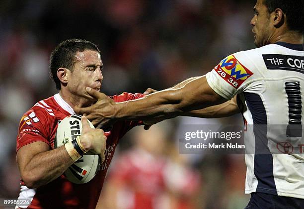 Darius Boyd of the Dragons is tackled by Ben Teo of the Broncos during the round 24 NRL match between the St George Illawarra Dragons and the...