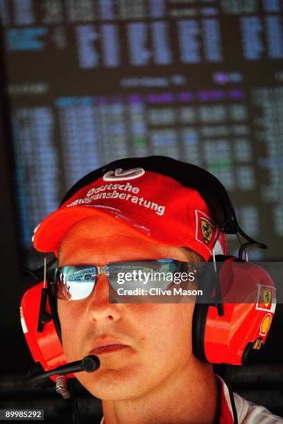 Former Ferrari F1 World Champion Michael Schumacher of Germany watches from the pitwall during practice for the European Formula One Grand Prix at...