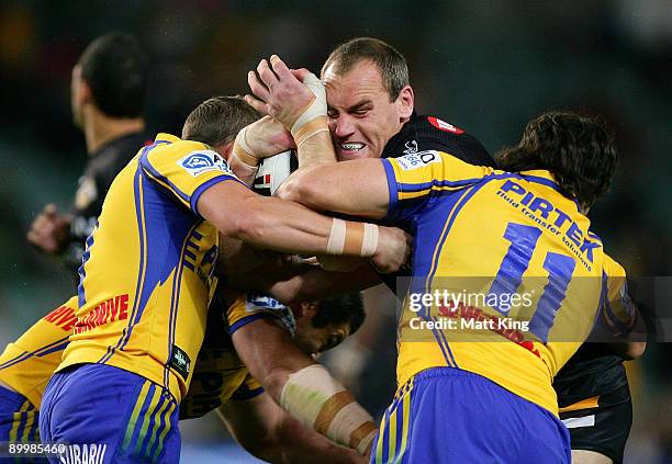 Gareth Ellis of the Tigers is tackled during the round 24 NRL match between the Wests Tigers and the Parramatta Eels at the Sydney Football Stadium...