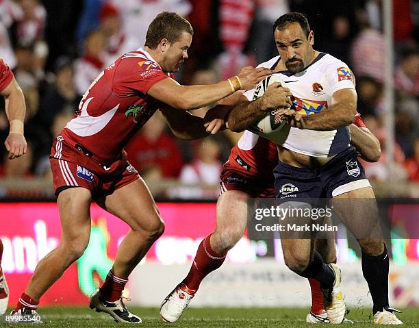 Tonie Carroll of the Broncos is tackled during the round 24 NRL match between the St George Illawarra Dragons and the Brisbane Broncos at WIN Stadium...