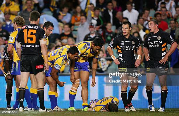 Luke Burt of the Eels lies on the ground after being kneed in the back by Bryce Gibbs of the Tigers after scoring a tryduring the round 24 NRL match...