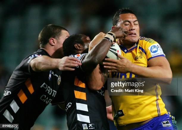 Feleti Mateo of the Eels takes on the defence during the round 24 NRL match between the Wests Tigers and the Parramatta Eels at the Sydney Football...