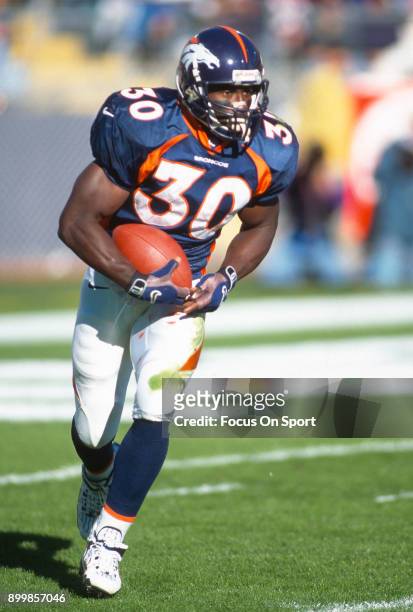 Terrell Davis of the Denver Broncos carries the ball against the Seattle Seahawks during an NFL football game November 2, 1997 at Mile High Stadium...