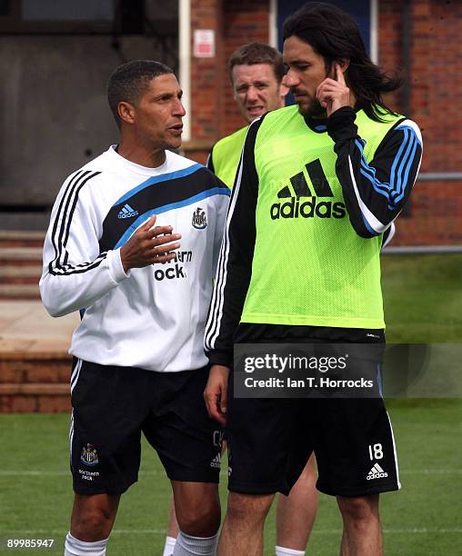 Chris Hughton talks to Jonas Gutierrez during a Newcastle United training session at the Little Benton training complex on August 21, 2009 in...