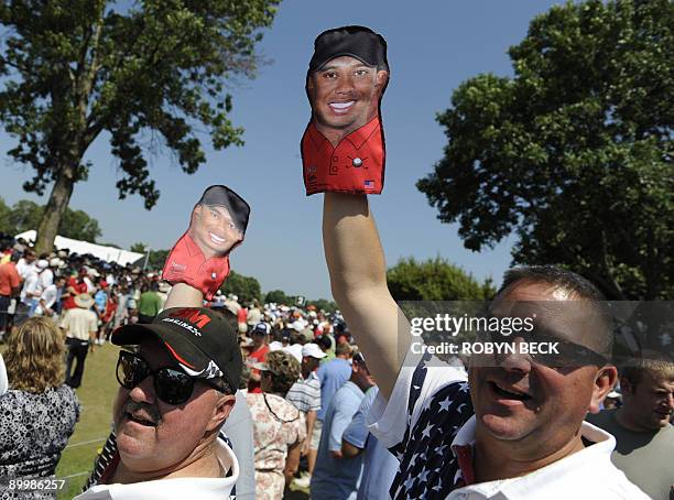 Fans holds Tiger Woods puppets as they wait to see Woods on the course during the second round of the 91st PGA Championship at the Hazeltine National...