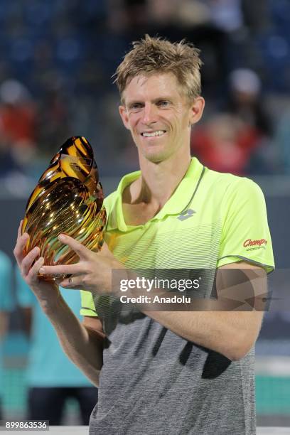 Kevin Anderson of South Africa celebrates with the trophy after his final match against Roberto Bautista Agut of Spain on day three of the Mubadala...