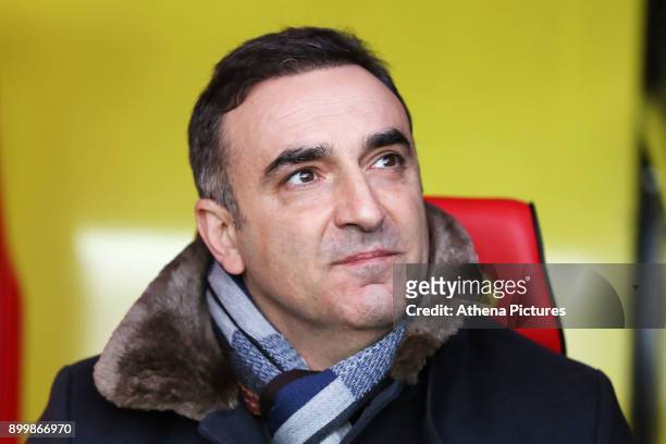 Swansea manager Carlos Carvalhal sits in the dugout during the Premier League match between Watford and Swansea City at the Vicarage Road on December...