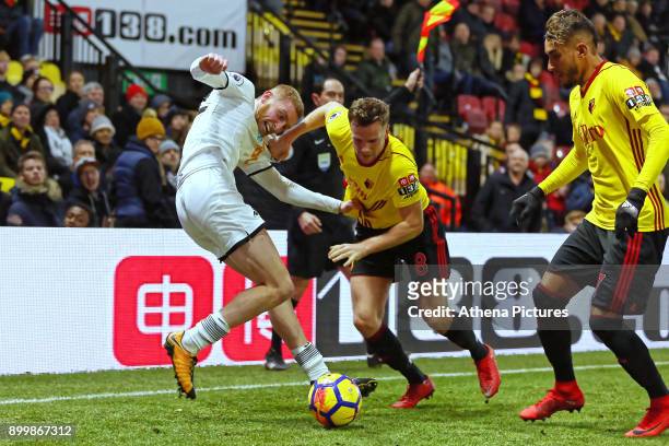 Oliver McBurnie of Swansea City challenged by Tom Cleverley and Roberto Pereyra of Watford during the Premier League match between Watford and...