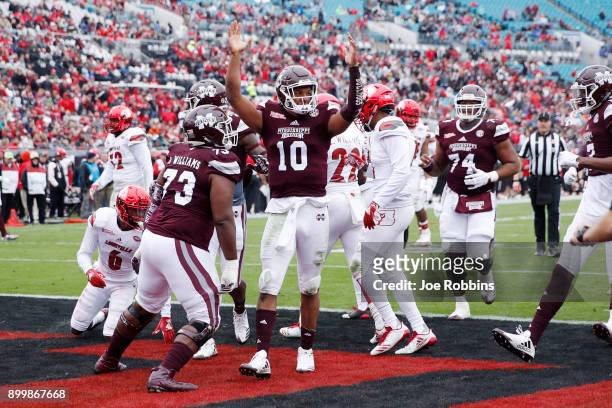 Keytaon Thompson of the Mississippi State Bulldogs reacts after rushing for a 14-yard touchdown in the first quarter of the TaxSlayer Bowl against...