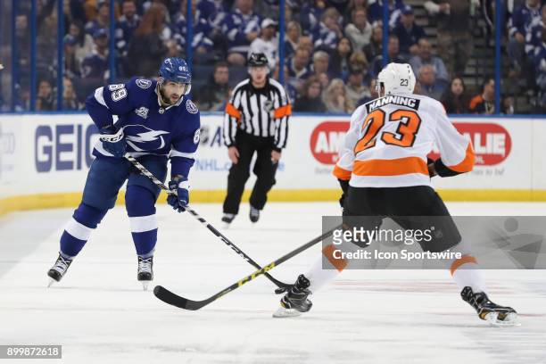 Tampa Bay Lightning center Cory Conacher skates the puck toward Philadelphia Flyers defenseman Brandon Manning in the second period of the NHL game...