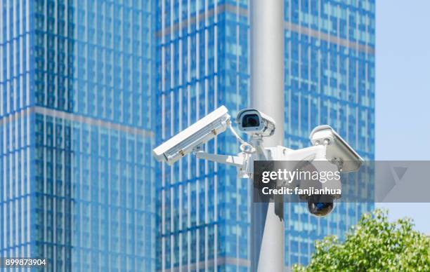 surveillance camera with modern buildings on background - surveillance screen stock pictures, royalty-free photos & images
