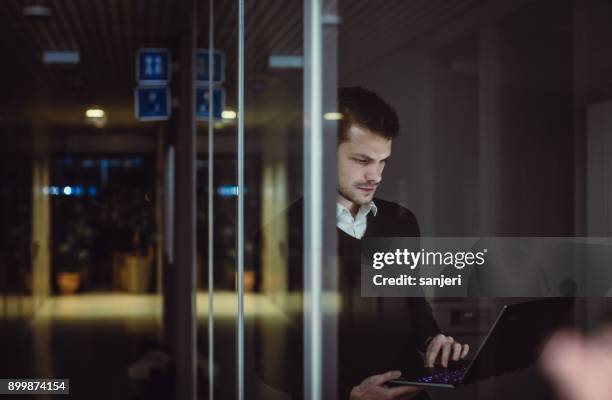 businessman working late in office - bank of slovenia stock pictures, royalty-free photos & images