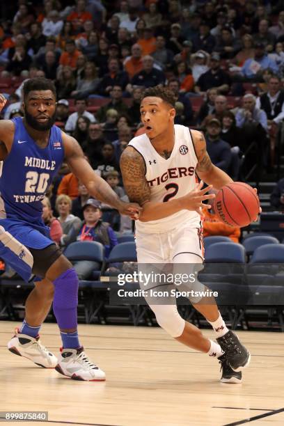 Auburn Tigers guard Bryce Brown drives past Middle Tennessee Blue Raiders guard Giddy Potts in the game between the Middle Tennessee Blue Raiders and...