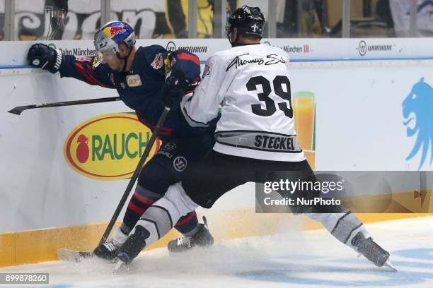 David Steckel of Nuernberg Ice Tigers vies Steve Pinizzotto of Red Bull Munich during 37th Gameday of German Ice Hockey League match between Red Bull...