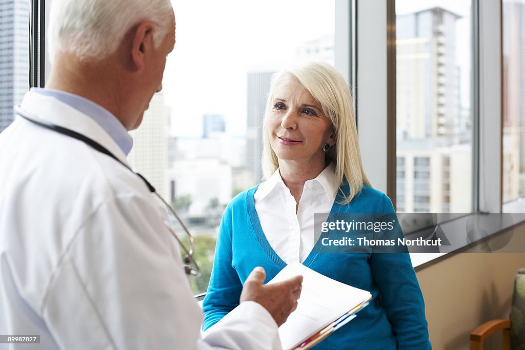 A senior woman listens carefully to her doctor
