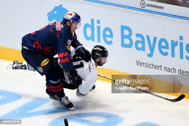 Keith Aulie of Red Bull Munich vies Philippe Dupuis of Nuernberg Ice Tigers during 37th Gameday of German Ice Hockey League match between Red Bull...