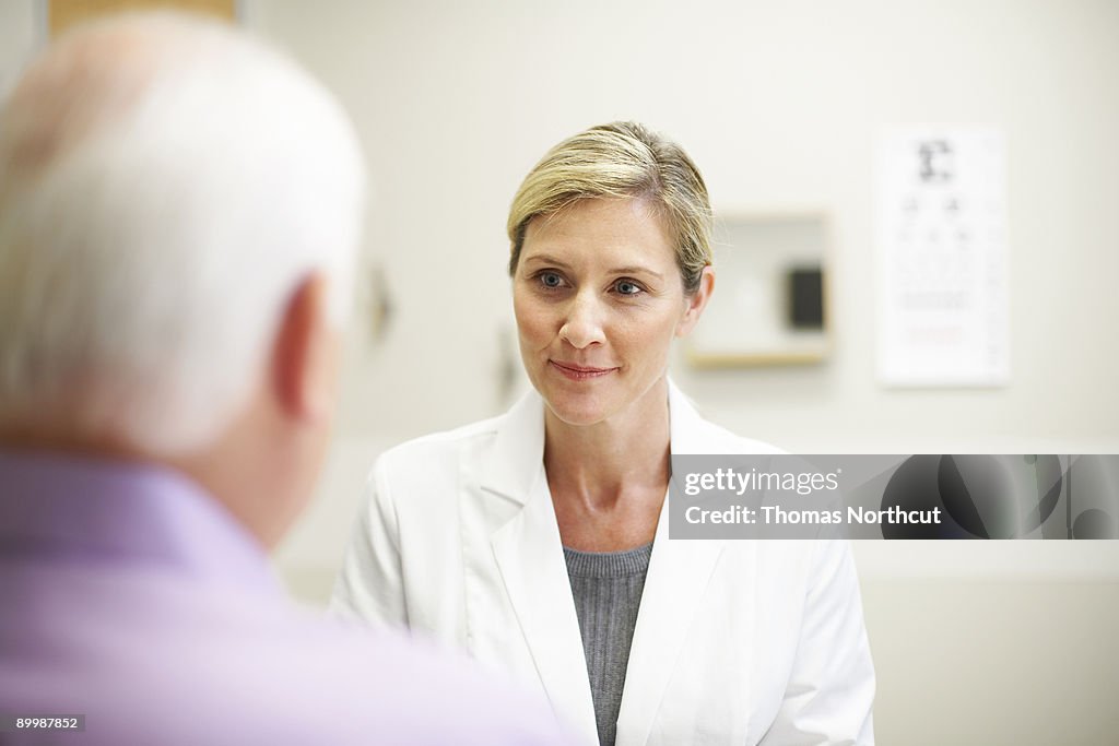 Female Doctor in conversation with mature patient