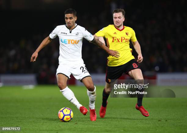 Swansea City's Kyle Naughton holds of Watford's Tom Cleverley during Premier League match between Watford and Swansea City at Vicarage Road Stadium,...