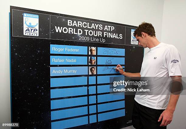 Andy Murray of Great Britain signs the Barclays ATP World Tour Finals leader board after qualifying for the eight-man event held at The O2 in London,...