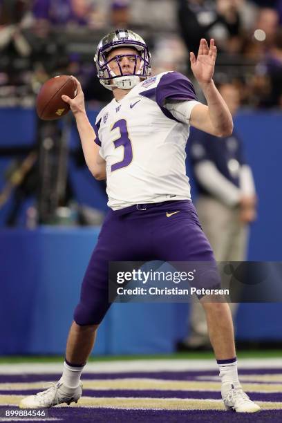 Quarterback Jake Browning of the Washington Huskies warms up before the Playstation Fiesta Bowl against the Penn State Nittany Lions at University of...