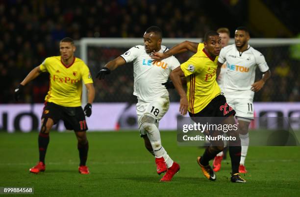 Swansea City's Jordan Ayew tussle with Watford's Marvin Zeegelaar during Premier League match between Watford and Swansea City at Vicarage Road...