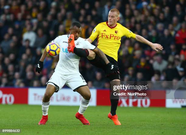 Swansea City's Jordan Ayew gets beaten by Watford's Ben Watson during Premier League match between Watford and Swansea City at Vicarage Road Stadium,...