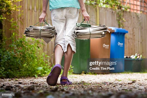 child recycling newspapers. - human role imagens e fotografias de stock