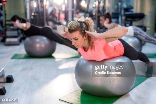 pilates stretching training - fitness ball stock pictures, royalty-free photos & images